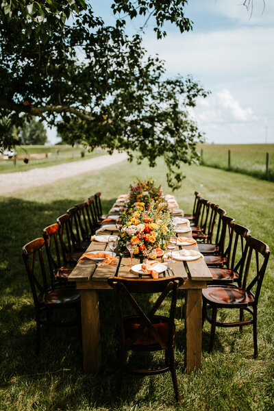 Outdoor bold and bright orange bridal shower inspiration at The Gathered, a nostalgic greenhouse based in Kathryn, Alberta wedding venue, featured on the Brontë Bride blog.