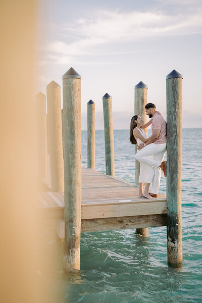 two women embracing with the ocean in the background