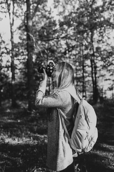 A photographer taking a picture in a forest