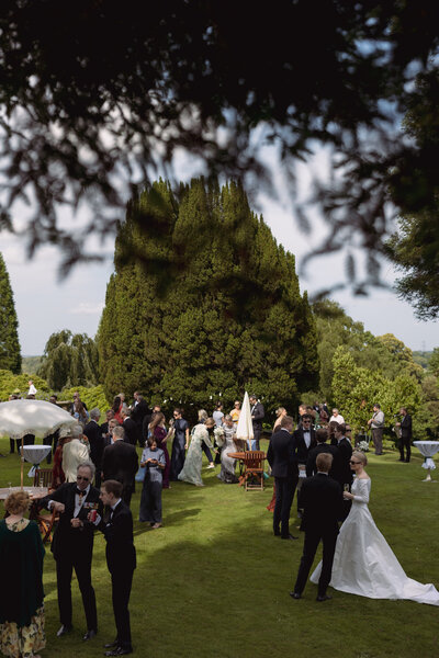 Wedding photographer captures couple taking a stroll hand in hand at their french chateau wedding.