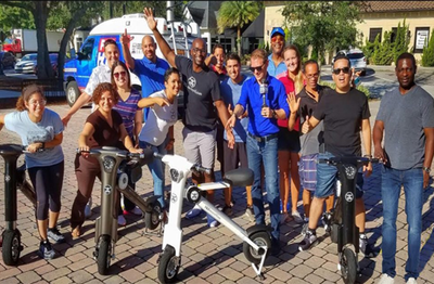 Couple riding white and bronze Go-Bike M1 around Orlando Florida Lake Eola