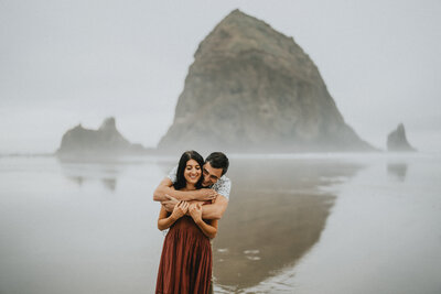 engaged couple at cannon beach elopement