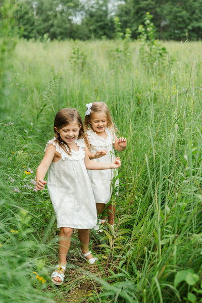 Sisters in a Field during a Minnesota Family Portrait Session