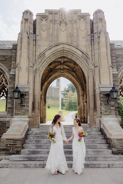 Women kissing wearing lace wedding dresses
