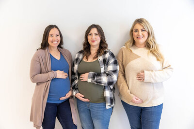 Group of pregnant women holding their bellies