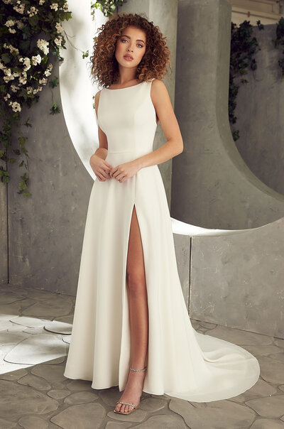 Paloma Crêpe Wedding Dress. Paloma Crêpe gown with modified sweetheart neckline, spaghetti straps, and draped sleeves. Beaded belt at waist. Fit and flare Crêpe skirt.
