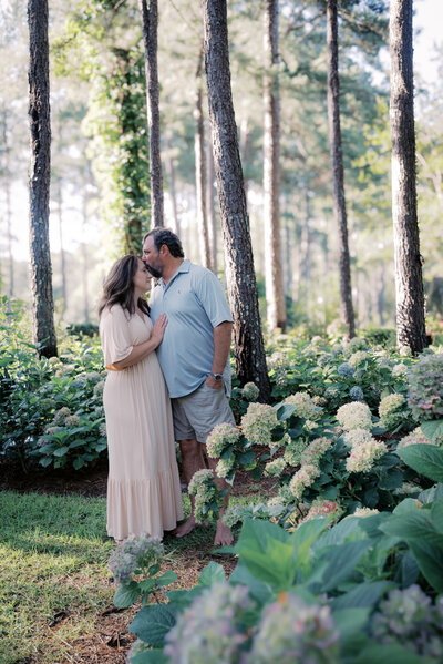 Husband gently kissing wife's forehead during romantic couples photography session in Bainbridge, GA, serving Tallahassee, FL