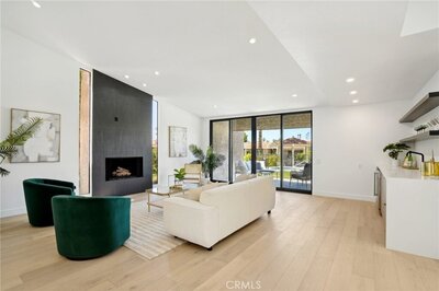 Home staged modern living room with teal chairs and white couch 