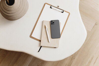 flatlay of pad, phone, pen and notebook