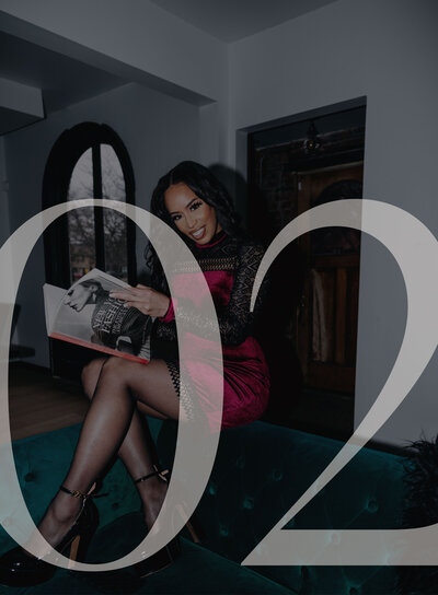 Woman in a red dress sitting on a teal couch with the number 02 overlaid on top