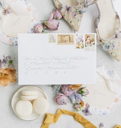 White envelope with lavender ink calligraphy and vintage postage stamps for Berkshires wedding at The Mount