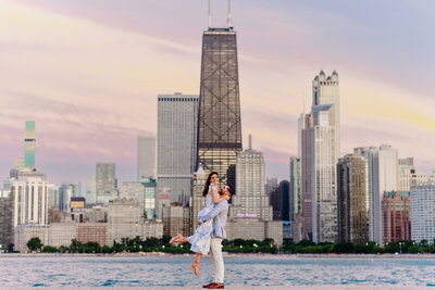Engaged couple with Chicago skyline behind them