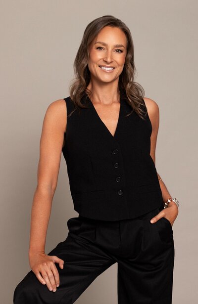 Stress, adrenal and thyroid Naturopath Lauren Glucina in a black suit.