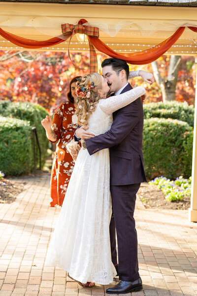 Bride kisses groom after saying "I do"  on their wedding day at the Manor House at Kings charter in  Richmond, Virginia.