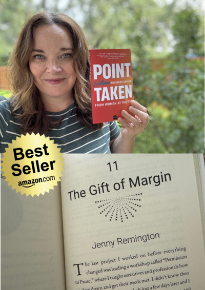 smiling woman holding up the book called Point Taken