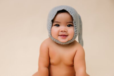 Close up portrait of baby with a grey bunny ear hat on