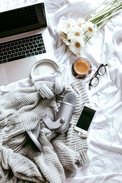 Laptop, headphones, podcast microphone and a blanket