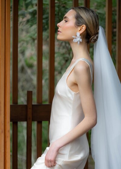 Editorial-style bridal look with sculpted bun and minimal makeup