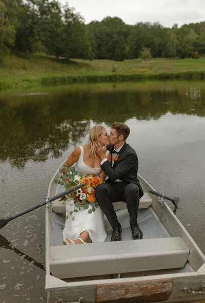Married couple on their wedding day taking photos in the fall in a private backyard