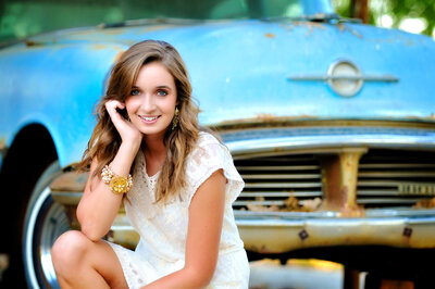 Senior girl in front of old car during senior pictures