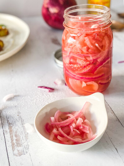 Pickled onions are a versatile condiment that can be eaten with a variety of dishes. Pair on sandwiches, burgers, and charcuterie boards!
