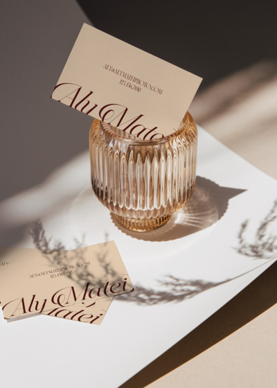 Aly Matei business cards in a glass with shadows on them