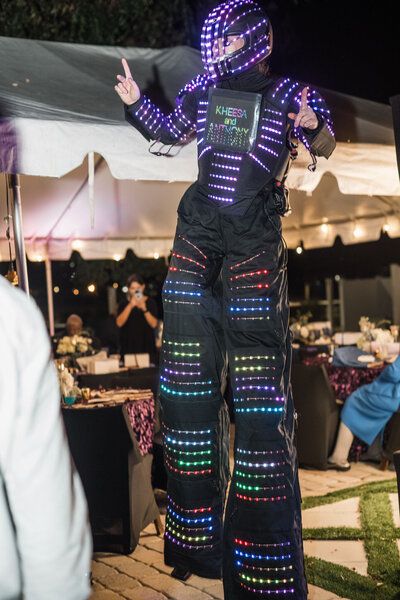 LED stilt performer at reception