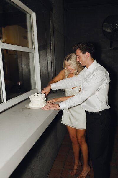 Bride and groom cutting their wedding cake