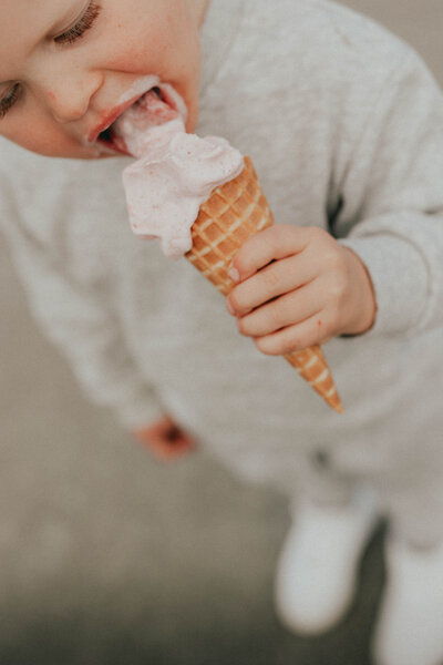Photo of a little boy licking a pink ice cream cone taken by a Langley Photographer