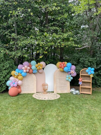 Bright and groovy balloon garlands attached to wooden backdrops