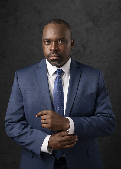 Couple holds sign announcing baby boy in maternity photos