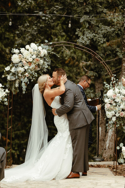 bride and groom kissing at alter