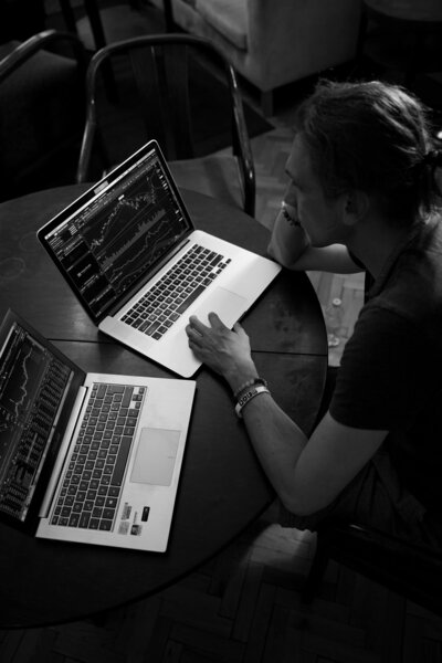 Man sitting with two laptops