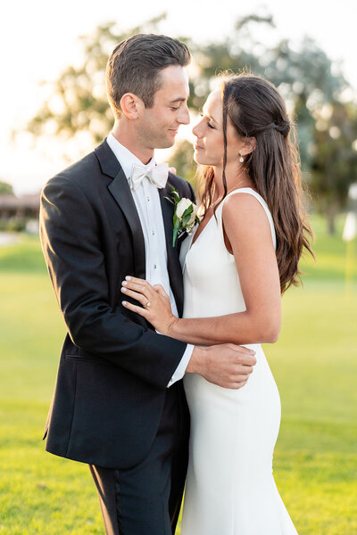 Bride and Groom kissing in vineyard at Falkner Winery