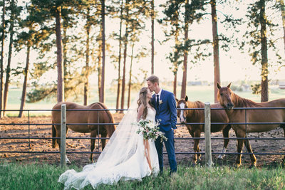 Makenzie and Blake embracing in front of horses