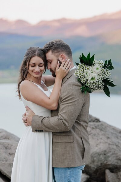 Bride and groom embrace following Colorado elopement ceremony.