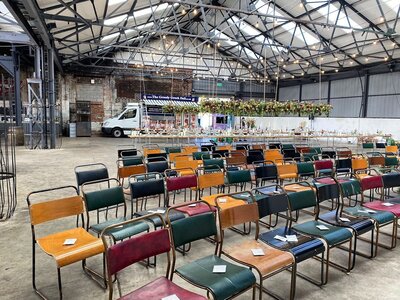 Wedding ceremony with  mismatched chairs at peddler warehouse