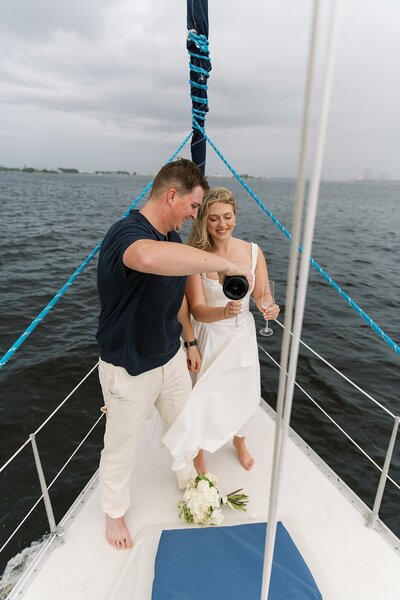 couple enjoying champagne on boat to show planning by wedding planners in southern new jersey