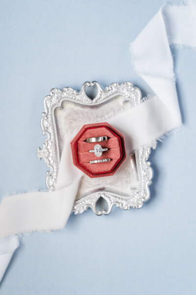 wedding flatlay with ribbon, tray and Burgundy wedding ring holder