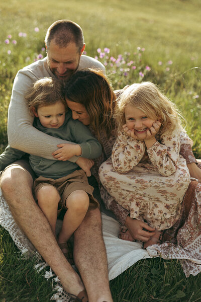 family laughing together in a backyard session