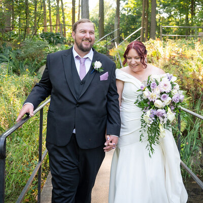 grooms holds brides face amongst flowers