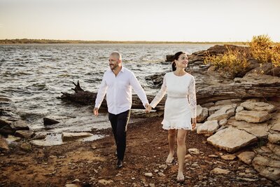 a couple walks hand in hand at Grapevine Lake