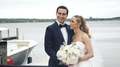 Bride and groom standing in front of water at Long Island wedding