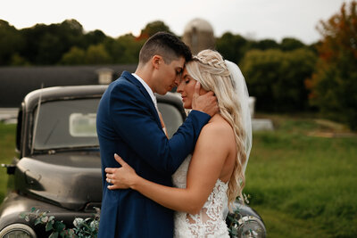 groom holding onto brides face during wisconsin wedding