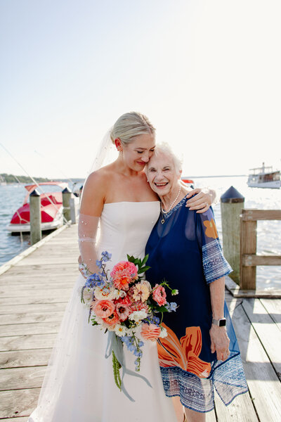 Bride takes portrait wearing blue feathered getting ready pajamas and sunglasses