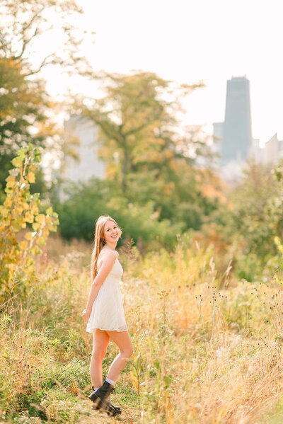 Girl in white dress in a meadow at Lincoln Park in downtown Chicago