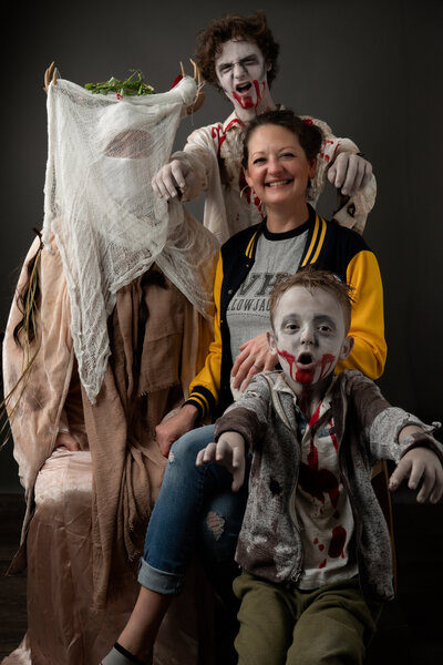 Family in Halloween Costumes, two boys dressed as Zombies, and parents in Yellowjackets costumes.