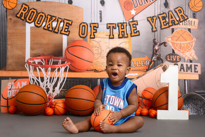 boy at his basketball themed first birthday photoshoot in houston