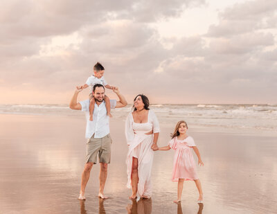 Children playing at the shoreline during family session in Central Florida