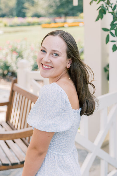 Senior looking over shoulder during portrait session at Hershey Gardens